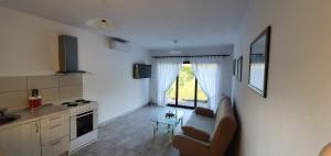 a kitchen with a couch and a table in a room at River House Buna in Mostar