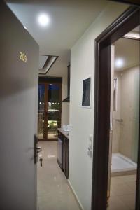a door leading to a bathroom with a shower at 24 Seven Boutique Hotel in Malia