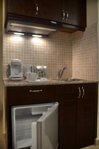 a kitchen with a sink and a counter top at 24 Seven Boutique Hotel in Malia