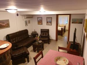 a living room with a couch and a table at Lake View Apartment Dodosi in Dodoši