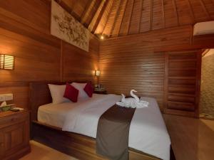 Tempat tidur dalam kamar di Kamasan Cottage