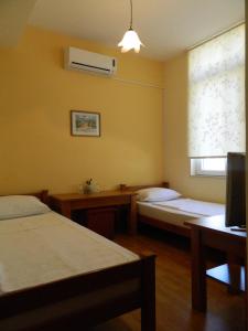 Postel nebo postele na pokoji v ubytování Pansion Centar