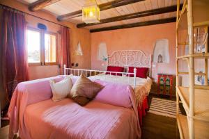 a bedroom with a bed and a bunk bed at Hubara Retreat in Charco del Palo