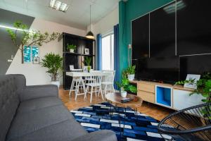 a living room with a couch and a tv at KemKay CityView ✩3s to HKLake✩Big Balcony in Hanoi