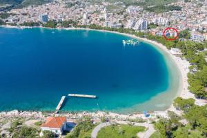 an aerial view of a beach with a boat in the water at Apartments Villa Bondi in Makarska