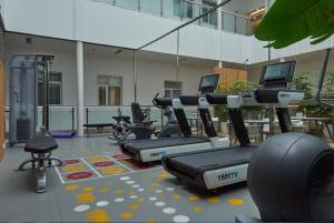 a row of exercise bikes in a gym at Ibis Shanghai New Hongqiao in Shanghai