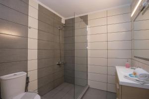 a bathroom with a shower and a toilet and a sink at Villa Martini in Kissamos +44 photos