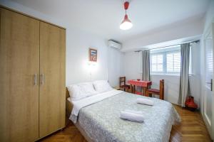 a bedroom with a bed and a cabinet and a table at Guest House Anica in Dubrovnik