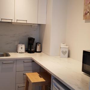 a kitchen with white cabinets and a counter top at Suojalantie 4 in Heinävesi