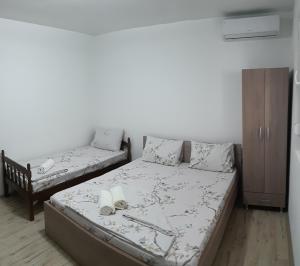 a small bedroom with a bed and a couch at Apartments Pinikot in Star Dojran