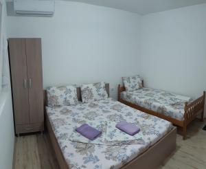 a small bedroom with a bed and a cabinet at Apartments Pinikot in Star Dojran