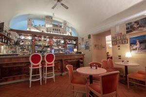 a restaurant with tables and chairs and a bar at Relais Ducale in Gubbio