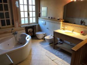 a bathroom with a tub and a sink and a toilet at Villa Bonelli Bed & Fest in Savigliano +61 photos