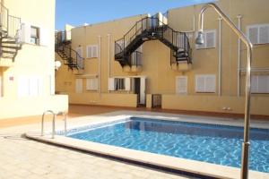 a large swimming pool in front of a building at Rascasa 2/5 in La Mata