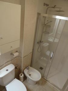 a bathroom with a shower and a toilet and a sink at Rascasa 2/5 in La Mata +11 photos
