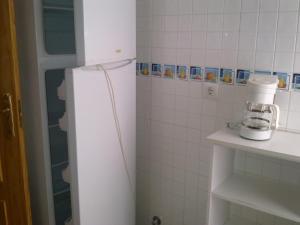 a kitchen with a white refrigerator in a room at Alojamiento Vacacional Inma in Cazorla +52 photos