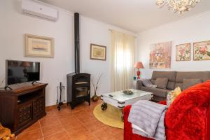 a living room with a couch and a fireplace at El Mirador de Bellavista in Conil de la Frontera