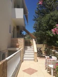 a stairway leading up to a house with a staircase at Adamas Rooms in Palaiochora