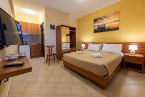 a hotel room with a bed and a television at Summer Sun in Skala
