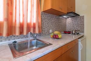 a kitchen counter with a sink and a window at Summer Sun in Skala