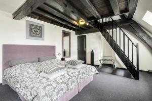 a bedroom with a large bed and a staircase at Hotel Kasteel Doenrade in Doenrade +72 photos