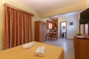 a room with a bed and a living room at Summer Sun in Skala