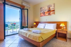 a bedroom with a bed with two towels on it at Summer Sun in Skala