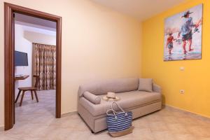 a living room with a couch and a mirror at Summer Sun in Skala