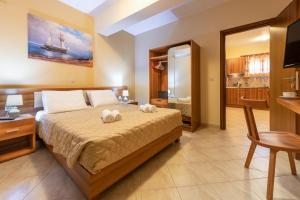 a bedroom with a bed with two stuffed animals on it at Summer Sun in Skala