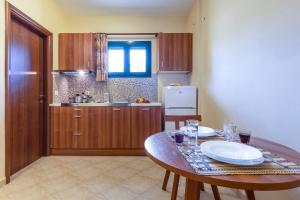 a kitchen with a table with two plates on it at Summer Sun in Skala