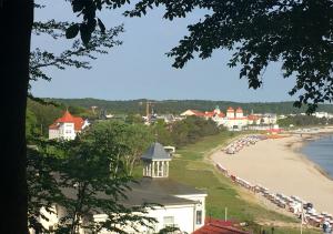 a view of a beach with a group of cars parked at Hotel Pension Haus Colmsee in Binz