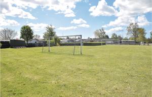 an empty field with a soccer goal in the grass at Three-Bedroom Holiday Home In Juelsminde in Sønderby +12 photos