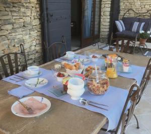 a wooden table with food on top of it at OUSTAU DE PIERA in Gordes