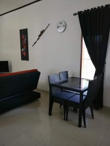 a black table and chairs in a room with a window at Dream Estate Resort in Senggigi