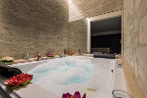 a bath tub filled with water in a bathroom at The Dream in Marina di Carrara +18 photos