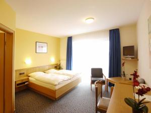 Postel nebo postele na pokoji v ubytování Hotel Hesborner Kuckuck + 25 fotografií