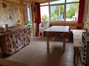 a kitchen with a table in a room with a window at Holiday House Krapets in Krapets