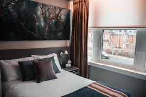 Ένα ή περισσότερα κρεβάτια σε δωμάτιο στο Hotel 55
