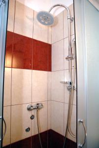 a shower with a glass door in a bathroom at Apartment Tina in Komiža +16 photos