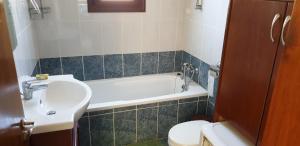 a bathroom with a sink and a tub and a toilet at JOANNA SUNSET APTS Pomos in Pomos +51 photos