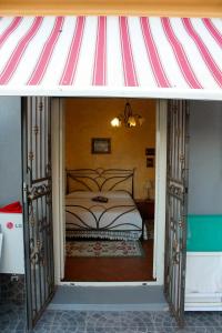 a bedroom with a bed and a striped awning at Apartment Terrazza Greca in Agrigento