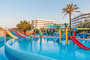 a swimming pool with a water slide in a resort at Alfagar Aparthotel in Albufeira
