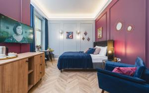 a bedroom with purple walls and a bed and a tv at Art of Serenity in Krakow