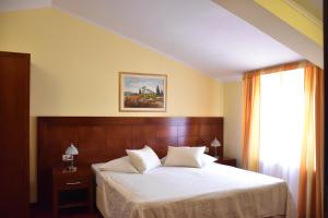 a bedroom with a bed and a window at Villa Riva in Makarska
