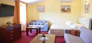ein Hotelzimmer mit einem Bett und einer Couch in der Unterkunft Villa Riva in Makarska