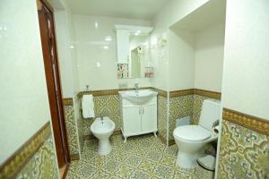 a bathroom with a toilet and a sink and a toilet istg at Muso To'ra Hotel- boutique in Khiva
