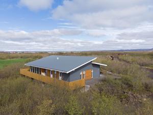 a house in the middle of a field at Birkilauf in Myvatn