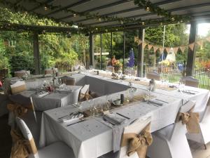 a long table with white tables and chairs at Strawberry Bank Hotel, NEC in Meriden