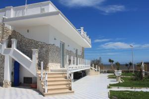 a white house with stairs in front of it at Casa Viky in Bari Palese