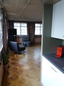 a kitchen and living room with a couch and a table at Hotel Garni Frohsinn in Uttwil